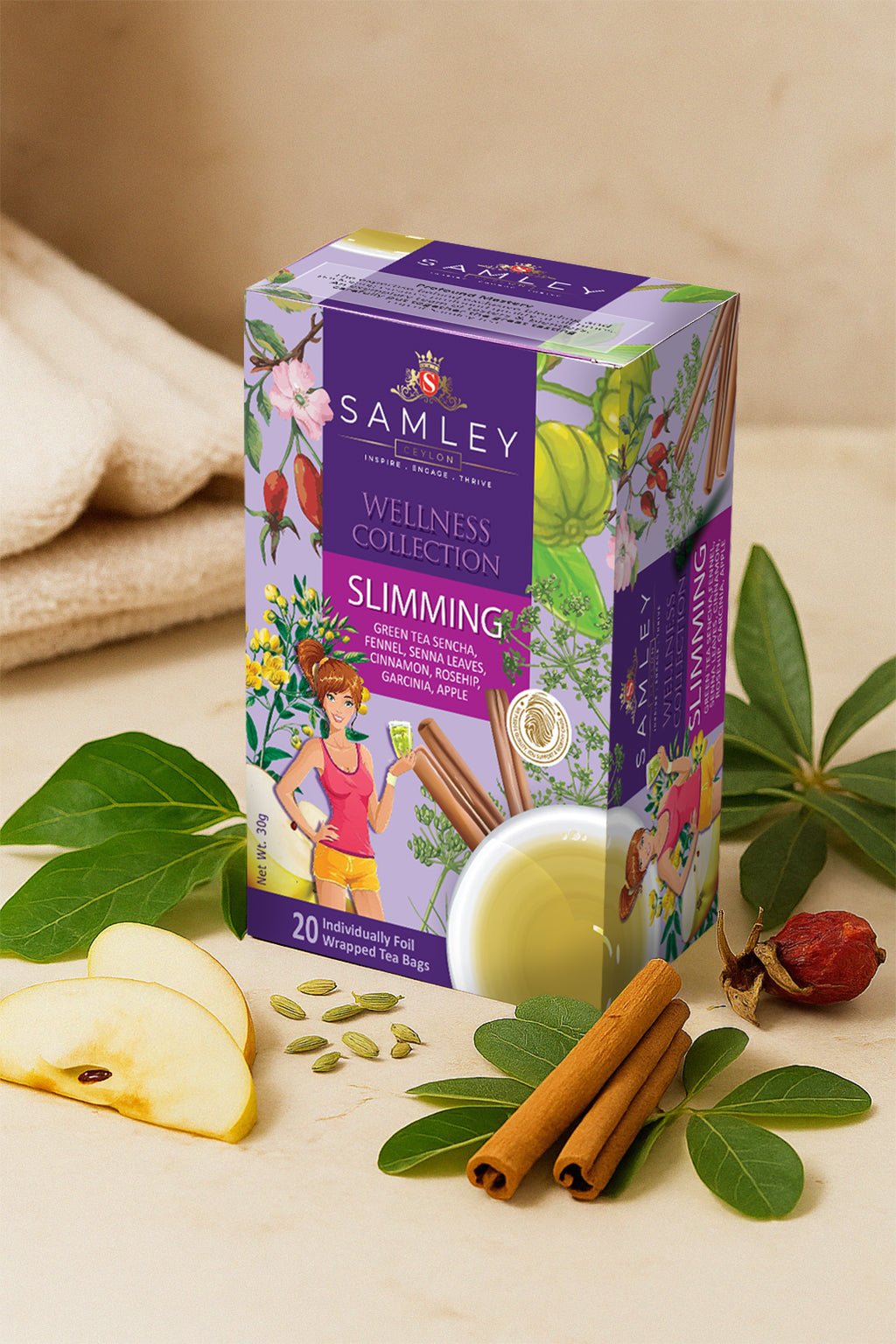 Teacord Wellness Collection Slimming tea box with senna leaves, cinnamon sticks, and an apple on a beige background